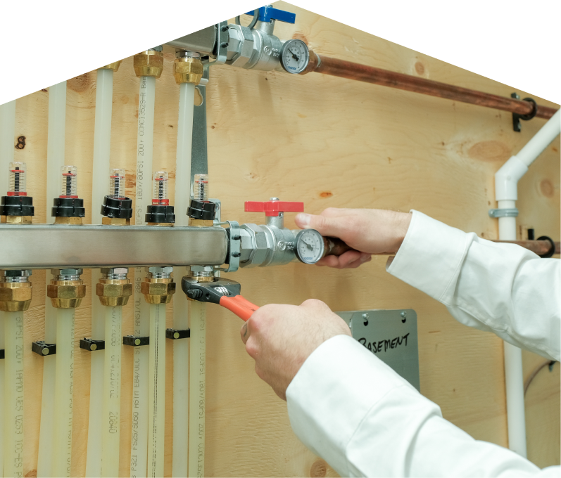 Dunn HVAC specialist performing boiler repair, adjusting internal components of a residential unit with visible copper piping and control wiring. Dunn HVAC specialist performing boiler repair, adjusting internal components of a residential unit with visible copper piping and control wiring.