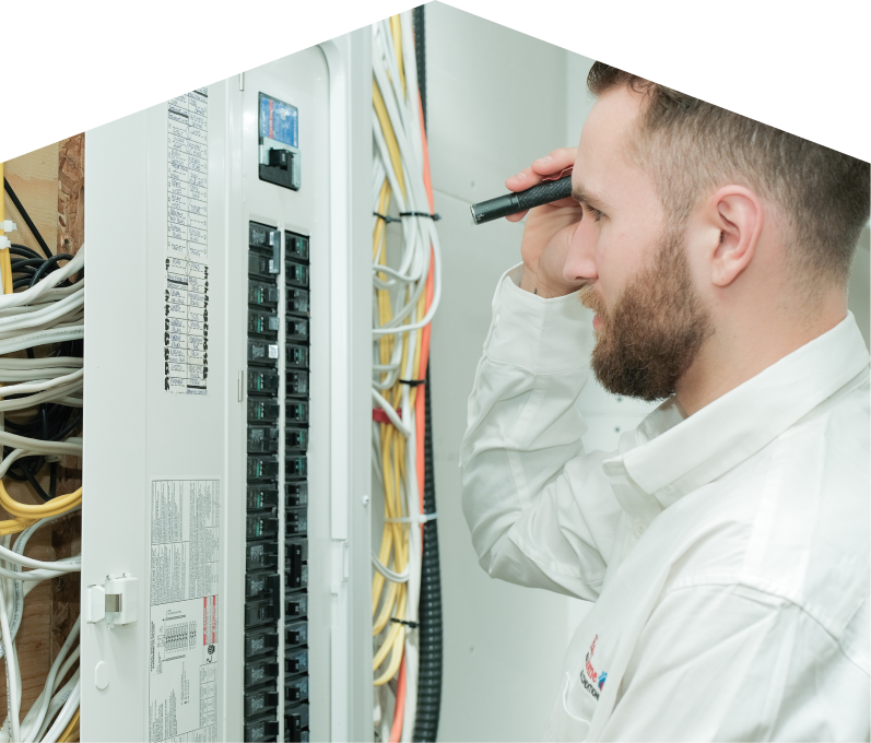 Dunn electrician inspecting residential electrical panel wiring with a flashlight, checking connections and circuit labels. Dunn electrician inspecting residential electrical panel wiring with a flashlight, checking connections and circuit labels.