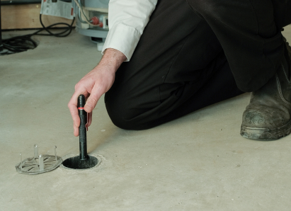 Dunn service personnel inserting a diagnostic tool into a floor drain for a residential drain and sewer service check. Dunn service personnel inserting a diagnostic tool into a floor drain for a residential drain and sewer service check.
